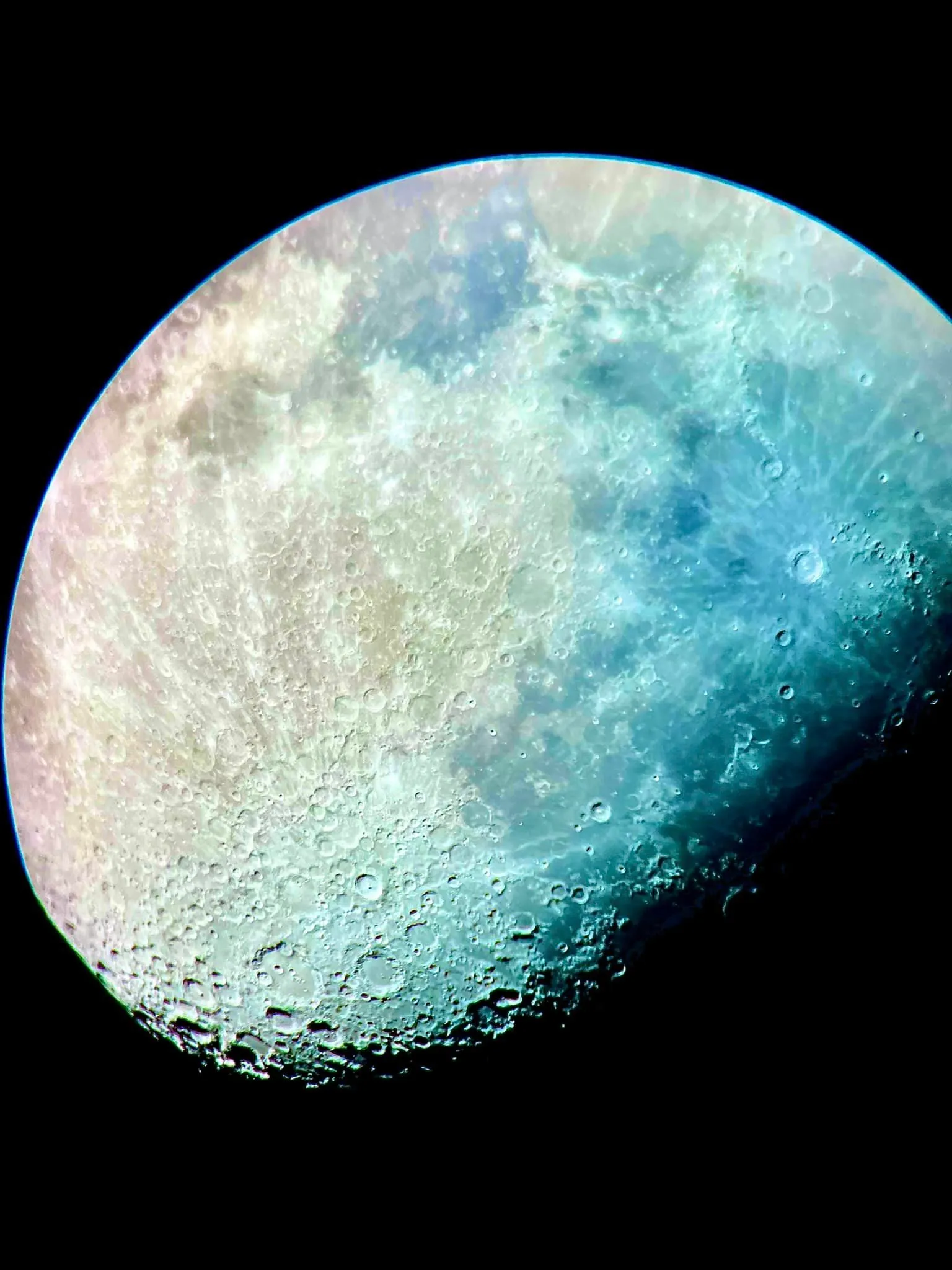 A waxing gibbous Moon with its mineral colors teased out in processing, blues and tans tracing iron and titanium across the maria.