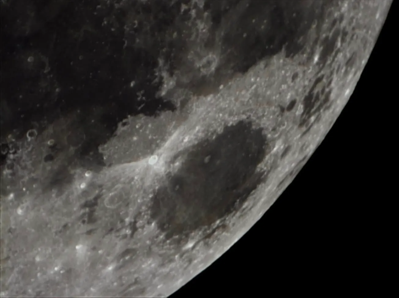 Crater detail near the terminator, where low sun angle throws the relief into sharp shadow.