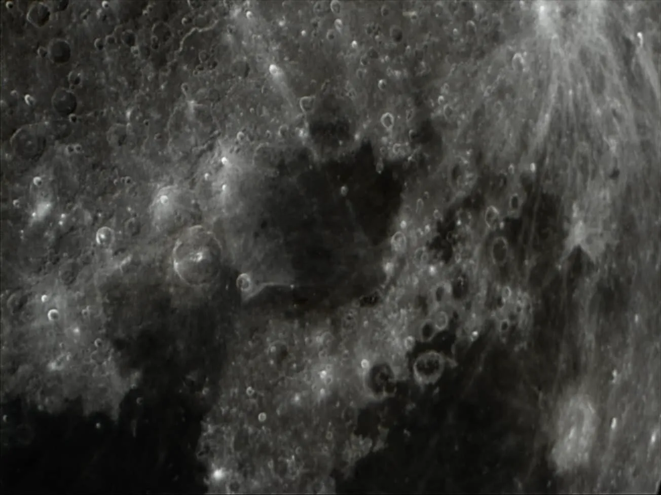 A close pass over the cratered southern highlands, bright ejecta rays splashing across older terrain.
